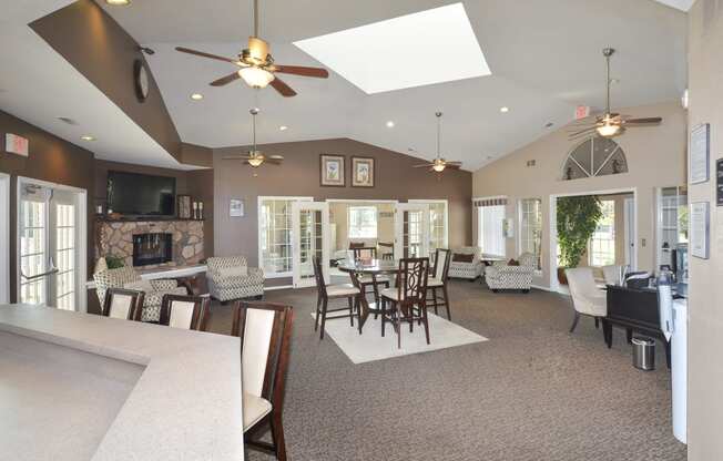 a large living room with a table and chairs and a fireplace