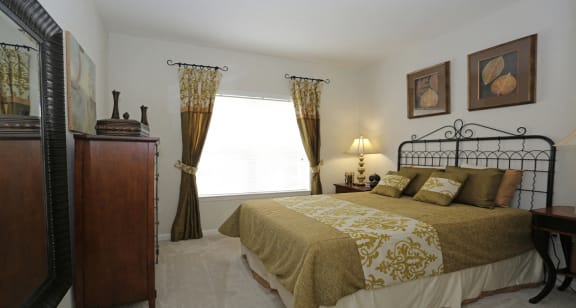 Guest bedroom with large windows for natural lighting at The Columns at Bear Creek, New Port Richey, Florida