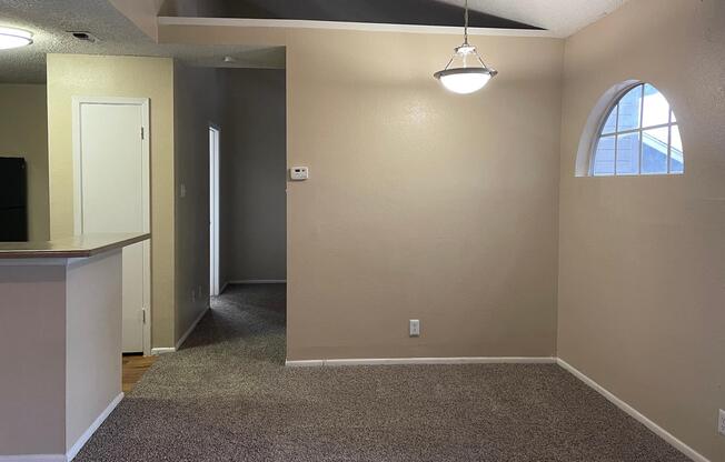 a large empty room with a sink and a mirror