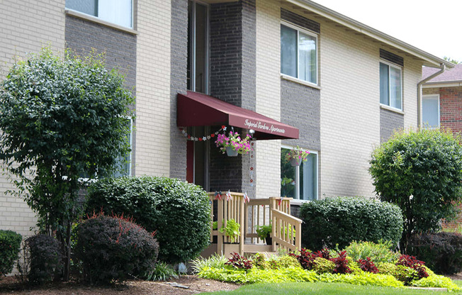 the front of a house with a porch and a garden