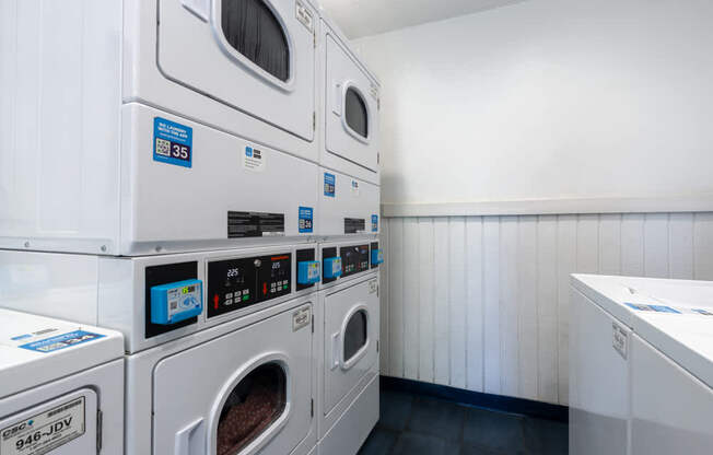 a washer and dryer in a laundry room with white walls