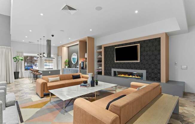 A modern living room with a fireplace and a television.