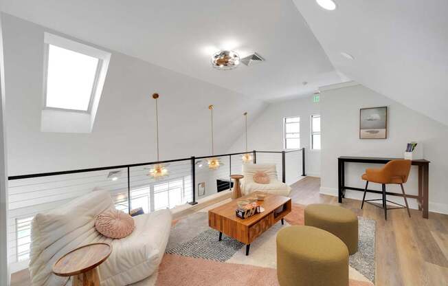 A living room with a white couch and a wooden coffee table.