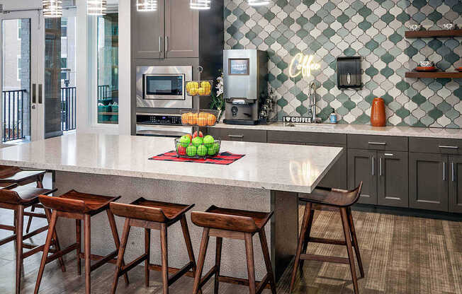 a kitchen with a large counter and some bar stools