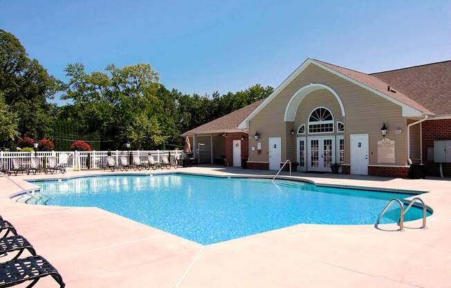 A pool with a building behind it.