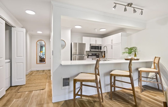 a kitchen with a bar and stools in a house