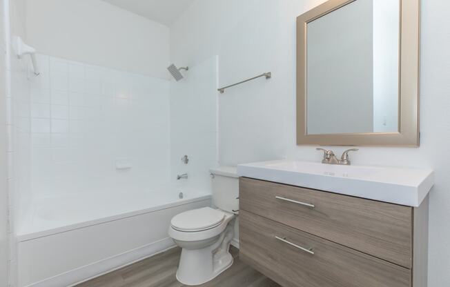 a bathroom with a toilet sink and bathtub in a 555 waverly unit
