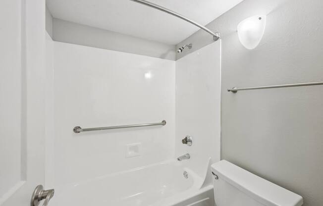 Model bathroom with a tub, toilet and sink.