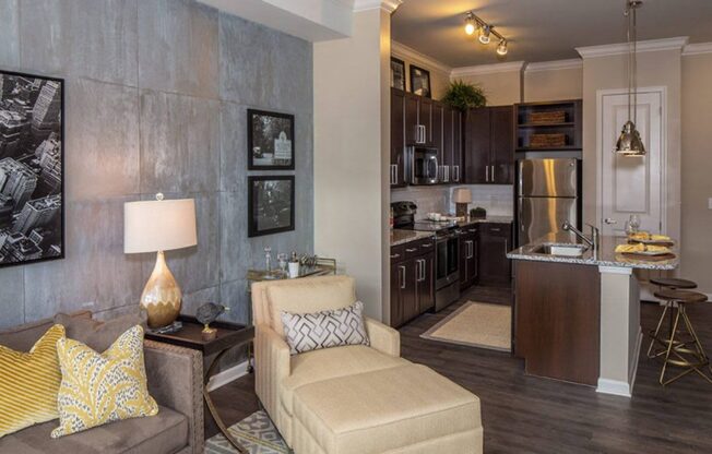 a living room and kitchen with a couch and a table