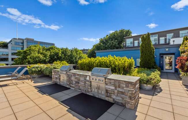 a fire pit on the roof of a building with a blue sky in the background at Dexter Lake Union, Seattle, WA
