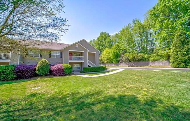 a house with a yard and a sidewalk in front of it