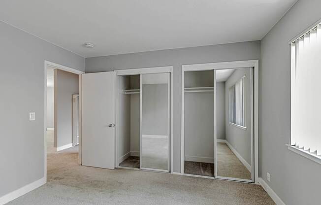 A room with a carpeted floor and a white wall.