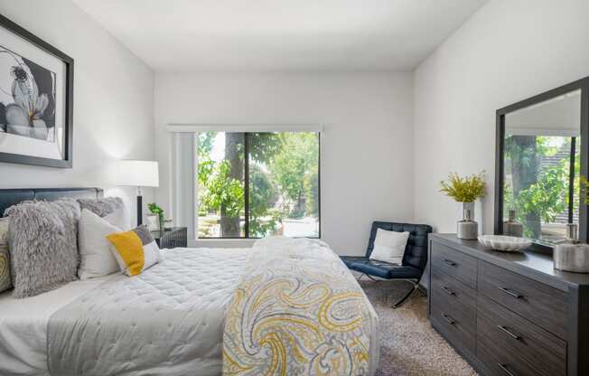 a bedroom with a large bed and a large window