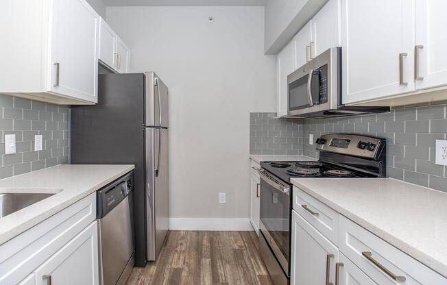 a kitchen with a stove sink and refrigerator