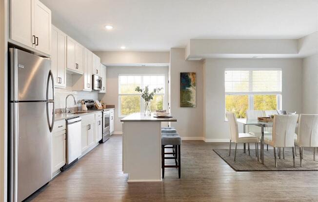 A modern kitchen with white cabinets and a large island.