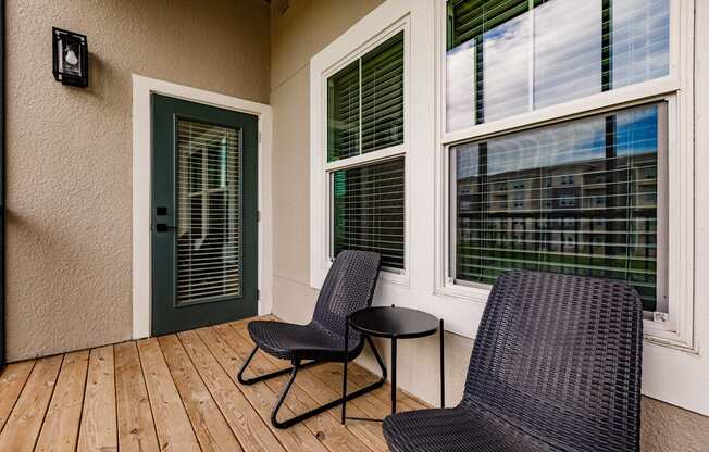 a balcony with chairs and a table