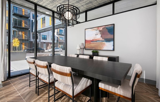 A modern dining room with a black table and chairs.