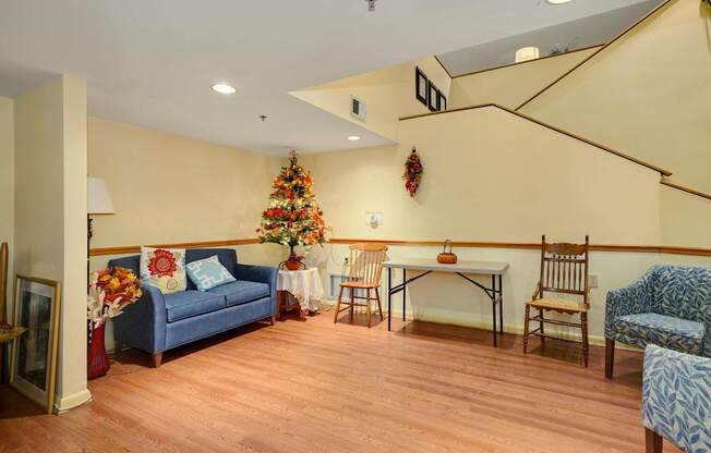 a living room with a couch and a table and a christmas tree