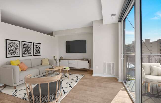 a living room with white walls and a sliding glass door that leads to a balcony