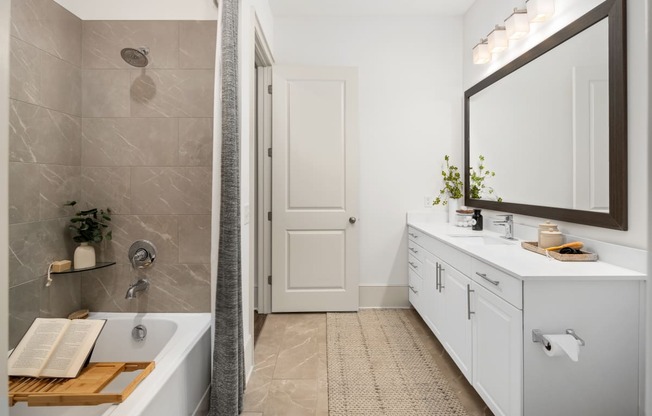 a bathroom with a tub and a sink and a mirror