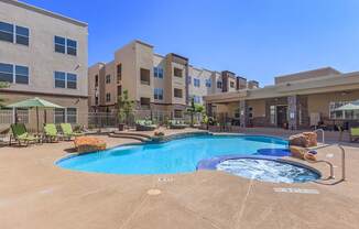 a large swimming pool in front of an apartment building