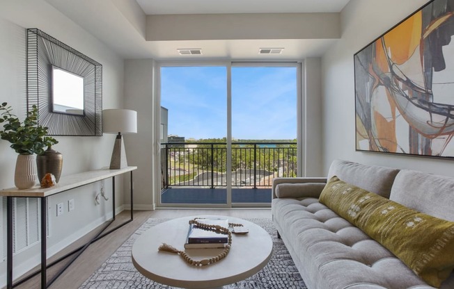 a living room with a couch coffee table and a large window