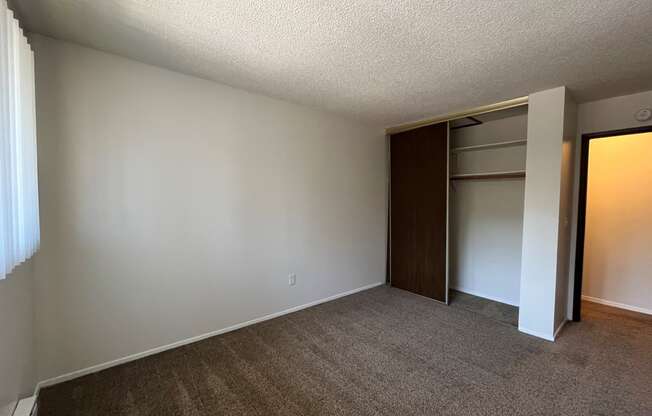 an empty bedroom with a closet