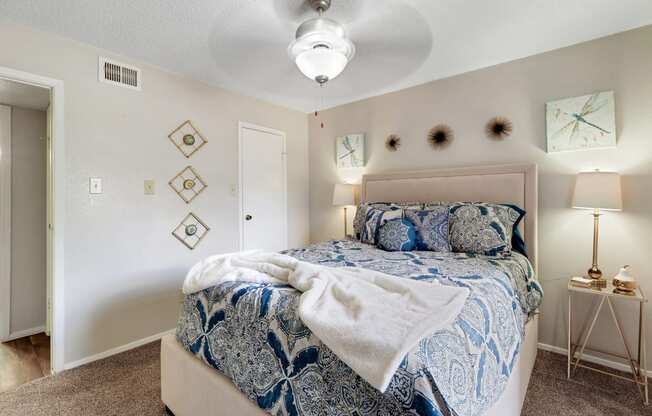 a bedroom with a bed and a ceiling fan