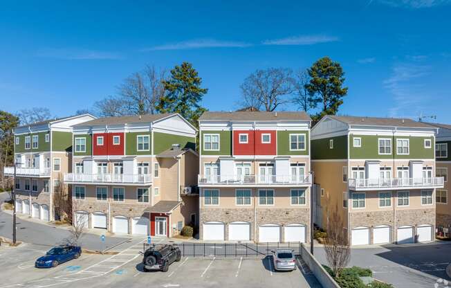 an image of an apartment building with cars parked in front of it