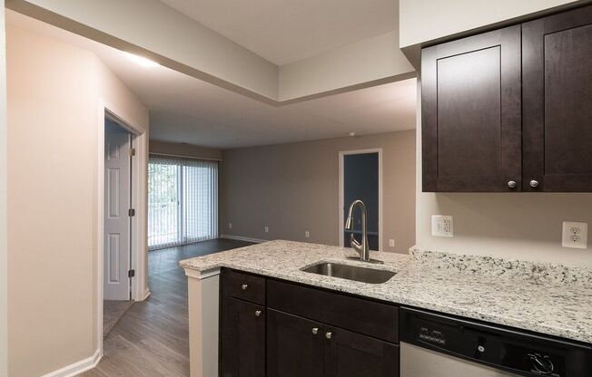Kitchen with stainless steel appliances and granite countertops at Elme Manassas, Virginia