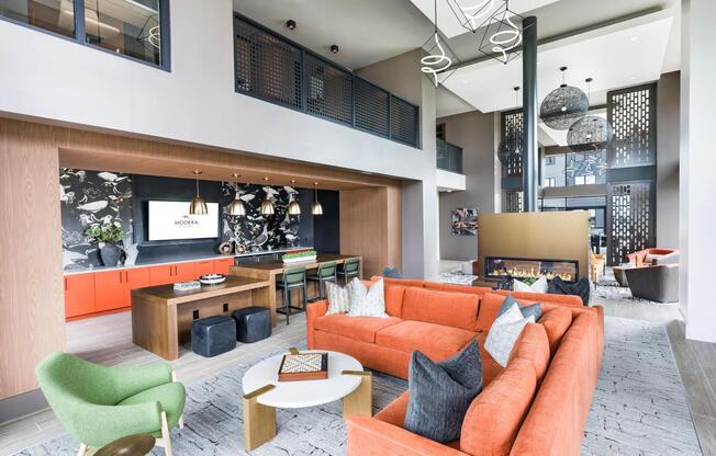 Vibrant resident lounge with a cozy fireplace, and versatile seating—perfect for hosting, relaxing, or connecting.