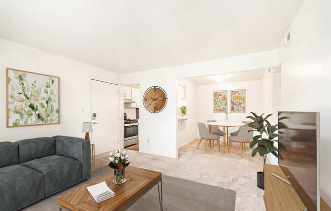 A living room with a couch and a dining room with a breakfast bar  and table with chairs at Irish Hills Apartments, South Bend, Indiana
