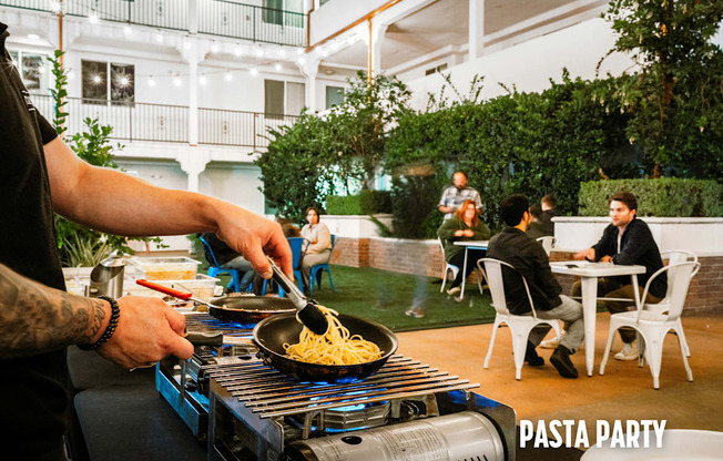 A man is cooking pasta for a pasta party.