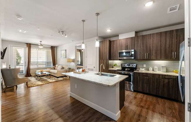 A modern kitchen with wooden cabinets and a white island.