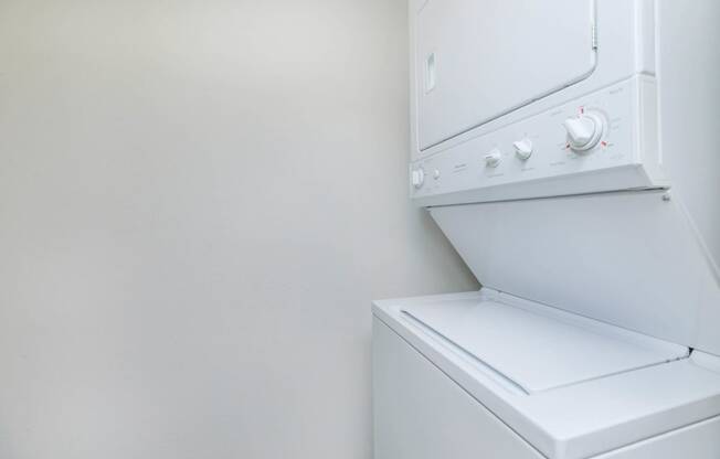 a washer and dryer in a room with a white wall  at Delano, Washington