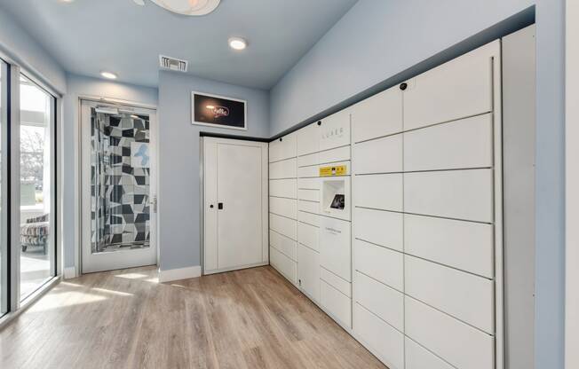 Luxer Package receiving system room with Hardwood Inspired Floor and Window at Morgan Ranch Apartments, California, 95037