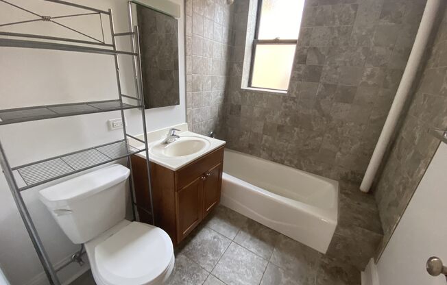 an empty bathroom with a toilet sink and tub