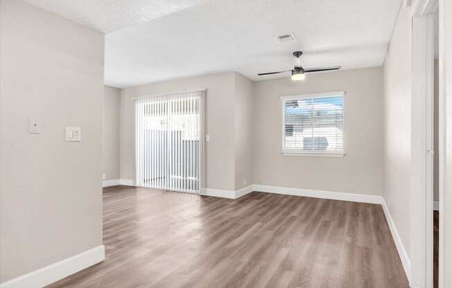 a bedroom with hardwood flooring and a window