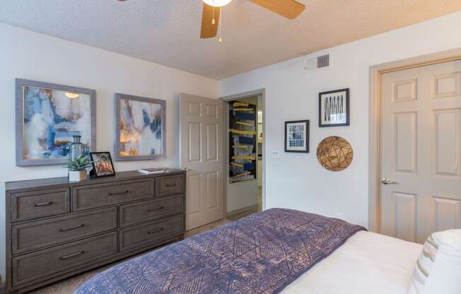 a bedroom with a large bed and a ceiling fan