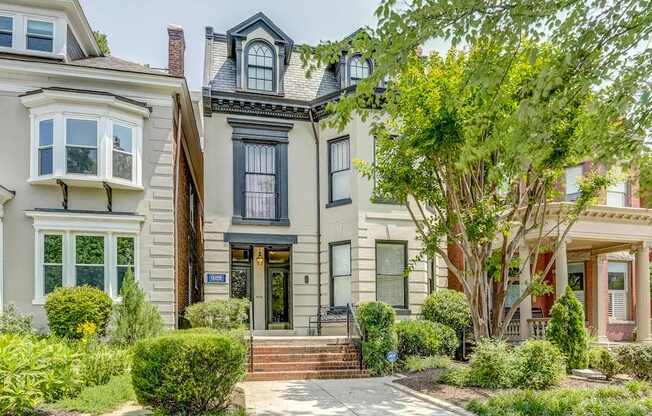 A house with a black front door and a small porch.