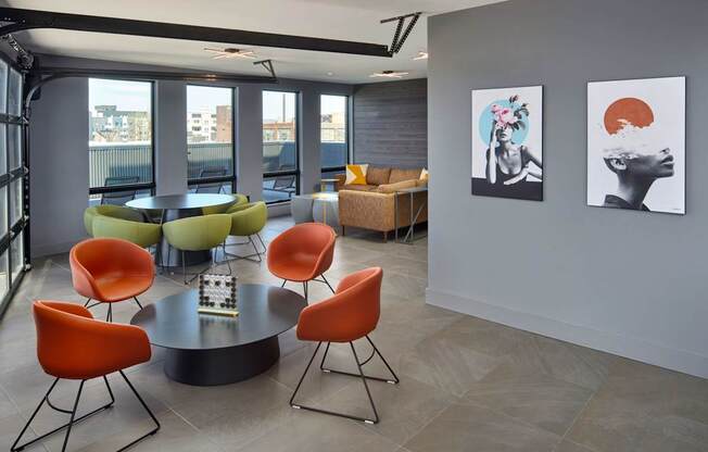 A modern dining room with a round table and chairs.