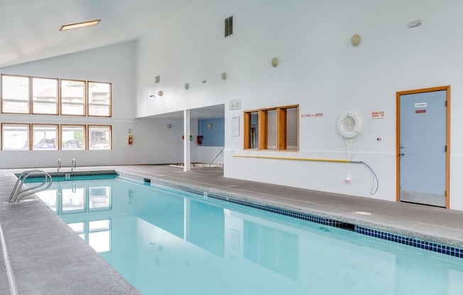 a swimming pool in a large room with a large window