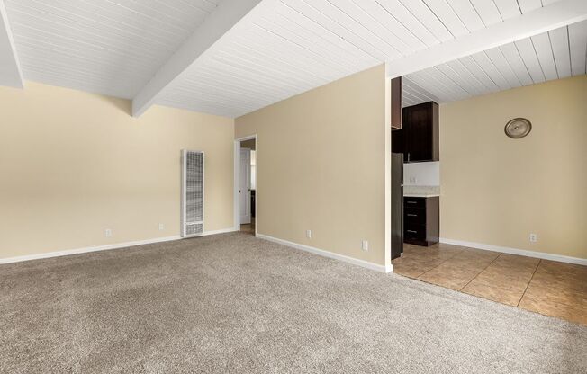 a living room with beige walls and a beige carpet