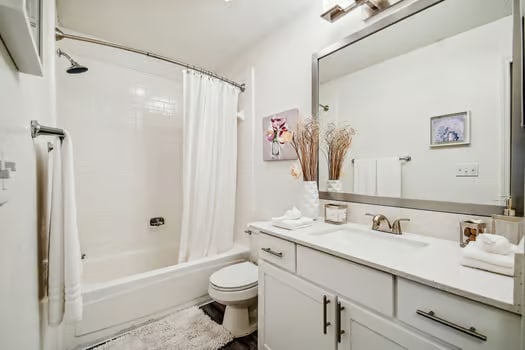 a bathroom with a shower toilet and sink