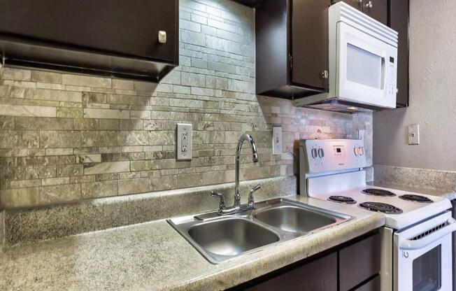 a stove top oven sitting inside of a kitchen