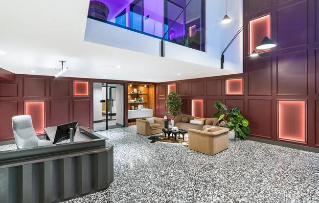 A bold lobby design welcomes you with layered textures, colorful lighting, and plush lounge seating.