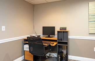 an office with a computer and a chair