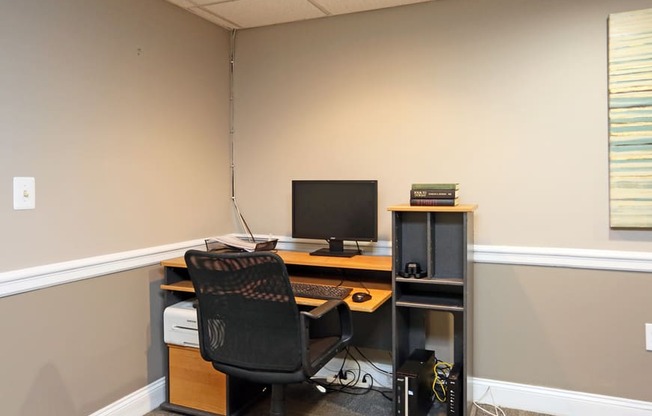 an office with a computer and a chair