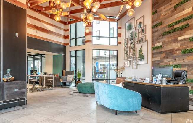 A reception area with a blue chair and a green ottoman.