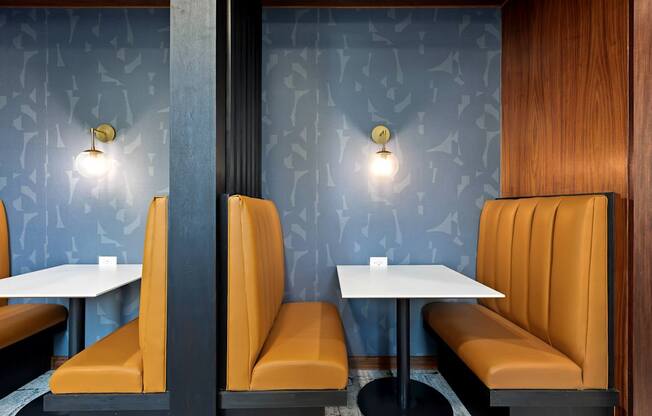 A restaurant with orange booths and tables.